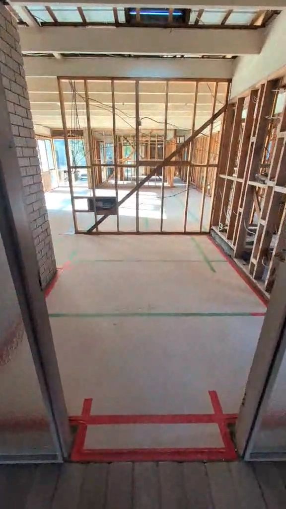 Construction site with exposed brick and framing